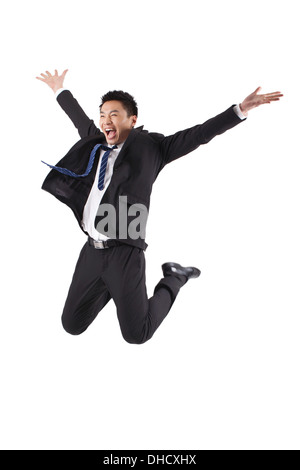 Portrait of young businessman jumping in white background Banque D'Images