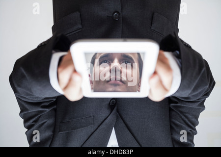 Portrait d'homme à l'envers avec face en tablette numérique. Banque D'Images