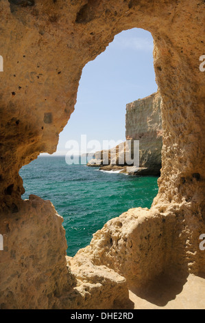 Afficher le long de la côte de la grotte dans les falaises de grès érodées fortement à Algar Seco parque, près de Carvoeiro, Algarve, Portugal. Banque D'Images