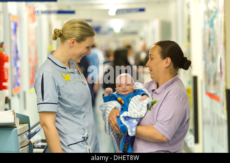 Une infirmière pédiatrique et travailleur de soins de s'occuper d'un bébé UK Banque D'Images