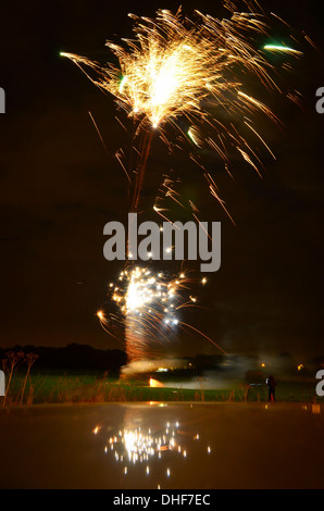 D'artifice qui explose dans l'air sur la nuit de Guy Fawkes reflétée dans le toit d'une voiture Banque D'Images
