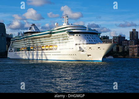 Rayonnement de la mer quitte Sydney au crépuscule, l'ombre de la Sydney Harbour Bridge tombant sur son côté tribord. Banque D'Images