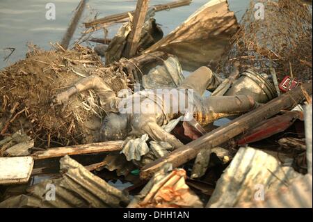 Banda Aceh, Aceh, Indonésie, . 4 janvier, 2005. Un corps GONFLÉ D'UN HOMME, apparemment gelé dans l'agonie et de l'impuissance, REPOSE SUR LES RIVES DE LA RIVIÈRE MAIN À BANDA ACEH 04 janvier 2005 après un énorme tsunami dévasté la région 26 décembre 2004. © Stephen Shaver/ZUMAPRESS.com/Alamy Live News Banque D'Images