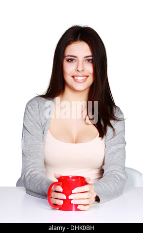 Belle Jeune femme tenant une tasse de sa boisson favorite, isolated on white Banque D'Images