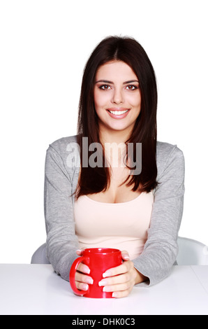 Belle Jeune femme tenant une tasse de sa boisson favorite, isolated on white Banque D'Images