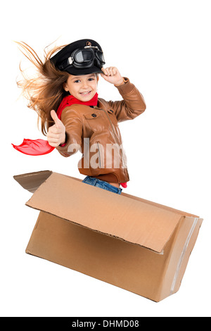 Jeune fille pilote aux commandes d'une boîte en carton blanc en isolé Banque D'Images