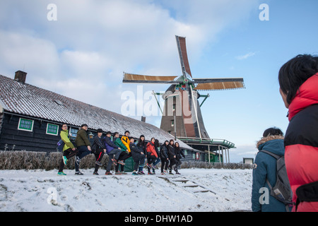 Pays-bas, Zaanse près de Zaandam, attraction touristique en plein air avec des moulins et maisons. L'hiver. Groupe de touristes asiatiques Banque D'Images