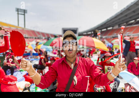 Bangkok, Thaïlande. 19 nov., 2013. Chemise rouge manifestants cheer pour haut-parleurs au cours d'une chemise rouge rassemblement à Bangkok. Jusqu'à 30 000 ''Red Shirts'' sont attendus à Bangkok cette semaine à l'avance d'une décision de la cour thaïlandaise qui pouvait provoquer l'effondrement du gouvernement de Yingluck Shinawatra, le premier ministre. Les chemises rouges sont réunis dans un stade de banlieue avant de marcher à la cour. Les chemises rouges sont pour la plupart des agriculteurs et ruraux thaïlandais qui appuient le gouvernement Shinawatra. Crédit : Jack Kurtz/ZUMAPRESS.com/Alamy Live News Banque D'Images