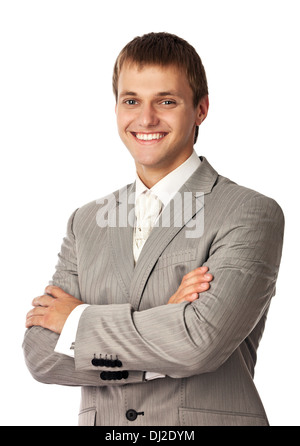 Young smiling man standing with arms crossed Banque D'Images