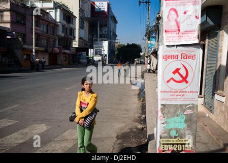 Katmandou, Katmandou, Népal. 19 nov., 2013. Une fille passé affiches électorales alors que marche le long de la rue vide Crédit : Agron Dragaj/ZUMAPRESS.com/Alamy Live News Banque D'Images