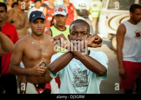 Un supporter de l'équipe adverse fait un geste fort au club Flamengo (Clube de Regatas do Flamengo) supporters de l'équipe whil Banque D'Images