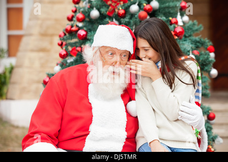 Le Père Noël à l'écoute du souhait de fille Banque D'Images