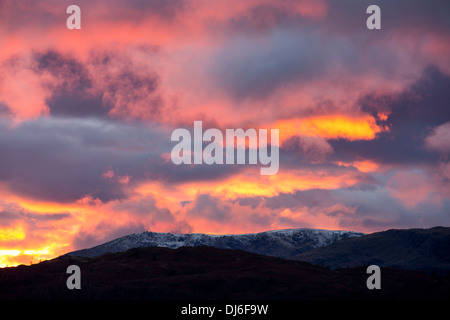 Un arbre de lumière tire sur une lacune dans les nuages au coucher du soleil, à l'origine d'une lueur dorée, Ambleside, Lake District, UK, Banque D'Images