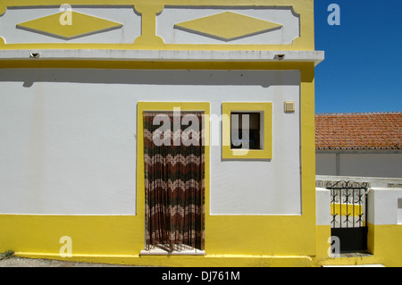 Maison typique avec des bandes d'encadrement jaune à Aljezur Algarve au Portugal du sud de la vieille ville Banque D'Images