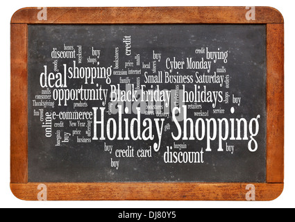 Le consumérisme concept - holiday shopping nuage de mots sur un tableau noir ardoise vintage isolated on white Banque D'Images