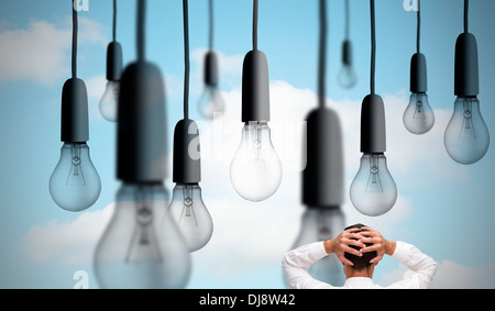 Businessman standing back to camera hands on head Banque D'Images