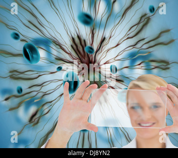 Blonde doctor holding virtual screen Banque D'Images