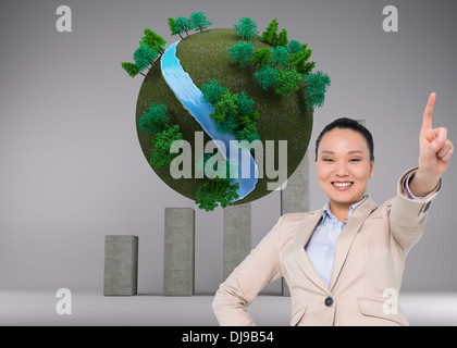 Composite image of asian businesswoman pointing Banque D'Images