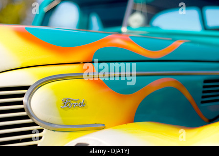 Un 1939 Ford V8 hot rod peint en bleu avec des flammes jaunes et blanches sur le capot, à partir de la vue de côté avant droit. Banque D'Images