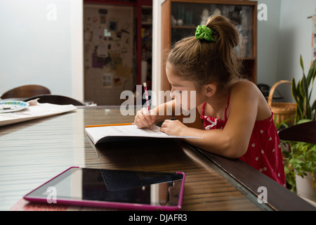 Mixed Race girl doing homework Banque D'Images