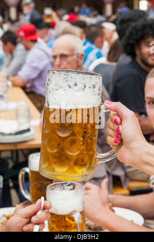 Germany, Bavaria, Munich, l'Oktoberfest, Woman's Hand Holding Beer Mug Banque D'Images