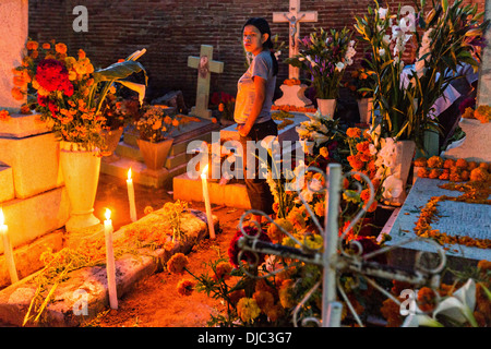 Une femme mexicaine à la tombe de la famille pour le jour de la fête des morts connus en espagnol comme día de muertos à l'ancien cimetière le 31 octobre 2013, au Mexique. Xoxocotlan dans Banque D'Images