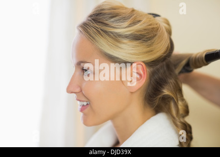 Cute blonde woman having her hair fait Banque D'Images