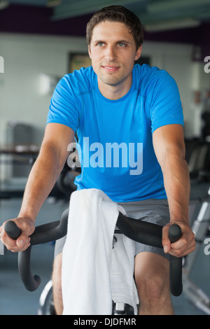 Smiling man working out at spinning class Banque D'Images