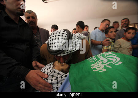 Hébron, en Cisjordanie, en territoire palestinien. 27 novembre 2013. Père de militant palestinien Mahmoud El-Najar embrasse lors de ses funérailles dans la ville de Cisjordanie d'Hébron, le 27 novembre 2013. Le bilan des décès de militants palestiniens de passer une nuit de combat avec des armes à l'armée israélienne en Cisjordanie a augmenté à quatre, les deux sources officielles israéliennes et palestiniennes a dit mercredi matin. (Xinhua/Mamoun Wazwaz/Alamy Live News) Banque D'Images