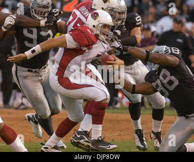 Aug 24, 2008 - Oakland, CA, USA - Arizona Cardinals quarterback MATT LEINART est freinée par Oakland Raiders défensive fin JAY RICHARDSON avec extrémité défensive TOMMY KELLY en étroite poursuite pendant un match au McAfee Coliseum. (Crédit Image : © AL GOLUB/Golub/Photographie Photographie Golub) Banque D'Images