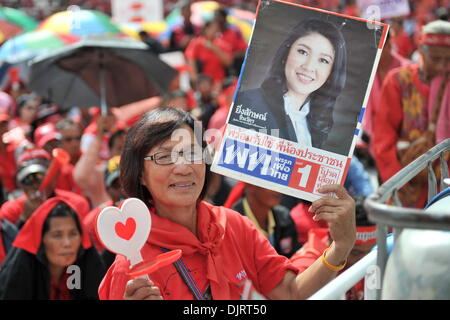 Bangkok, Thaïlande. 30Th Nov, 2013. Une chemise rouge partisan est titulaire d'une affiche du Premier Ministre thaïlandais Yingluck Shinawatra lors d'une manifestation à Bangkok, Thaïlande, le 30 novembre 2013. Des milliers de pro-gouvernement red-shirts assister à un rassemblement ici le samedi à l'appui de Yingluck Shinawatra comme une réponse à des manifestants anti-gouvernement rallyes en cours. Credit : Gao Jianjun/Xinhua/Alamy Live News Banque D'Images