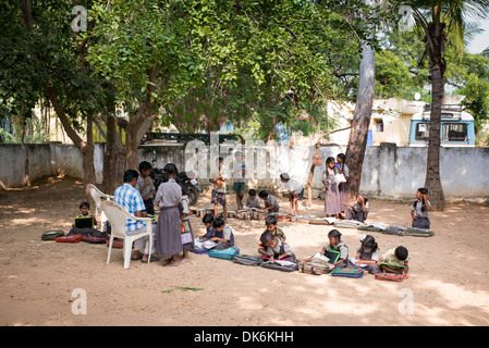 Enseignant de l'école du village de l'Inde rurale et des enfants dans une classe de l'extérieur. L'Andhra Pradesh, Inde Banque D'Images