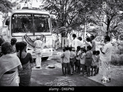 Sri Sathya Sai Baba l'hôpital clinique de services mobiles de proximité bus à une école du village de l'Inde rurale. L'Andhra Pradesh, Inde. Banque D'Images