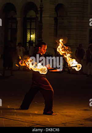 Jongleur de feu la nuit sur la Piazza dell'Unita d'Italia Square, Trieste, Italie Banque D'Images