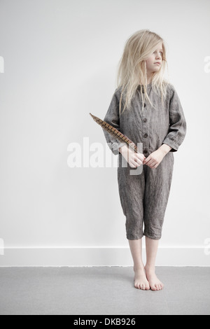 Portrait of Girl holding feather Banque D'Images