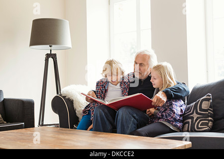 Livre de lecture grand-père à ses petits-enfants Banque D'Images