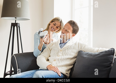 Couple, woman holding baby shoes Banque D'Images