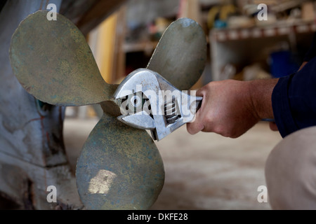 L'homme de serrer hélice de bateau en atelier Banque D'Images