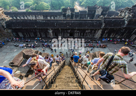 Les touristes monter des marches à la terrasse surélevée à Angkor Wat, Site du patrimoine mondial de l'UNESCO, Angkor, la Province de Siem Reap, Cambodge Banque D'Images