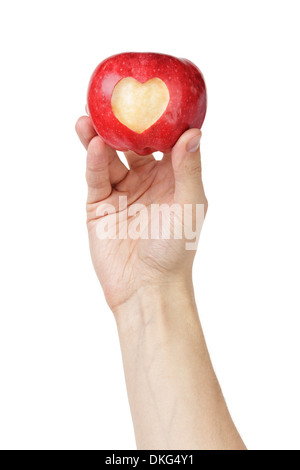 Main man holding apple avec coeur sculpté, isolated on white Banque D'Images