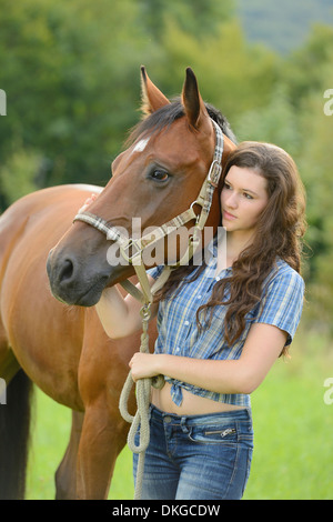 Teenage Girl standing avec un cheval sur un paddock Broderstorf Banque D'Images