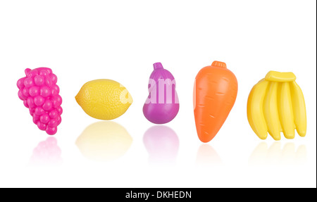 Les fruits, les légumes et les jouets en plastique isolé sur fond blanc Banque D'Images