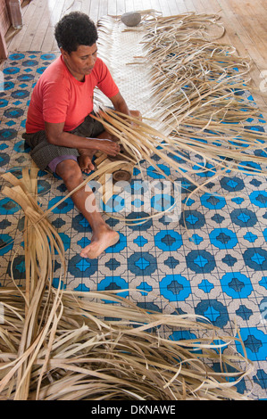 Ledua Tokasa tisser un tapis de pandanus dans la salle communautaire, Lomati, une des trois femmes tissant à l'époque. Matuku, Laus, Fidji Banque D'Images