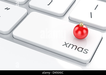 Le rendu 3D de boule de Noël sur le clavier de l'ordinateur. Concept de Noël Banque D'Images