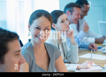 Businesswoman smiling in meeting Banque D'Images