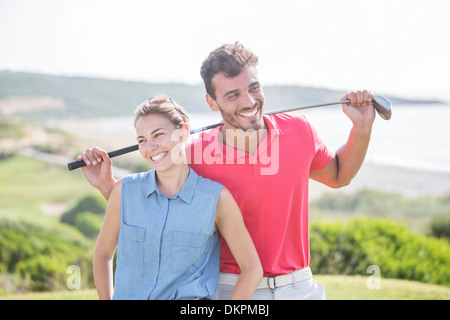 Happy couple on golf course Banque D'Images
