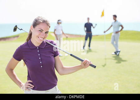 Woman smiling on golf course Banque D'Images