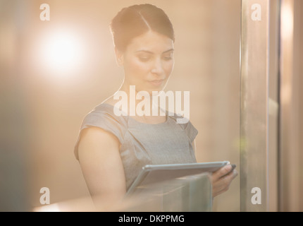 Businesswoman using digital tablet in office Banque D'Images