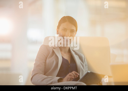 Businesswoman using digital tablet in office Banque D'Images