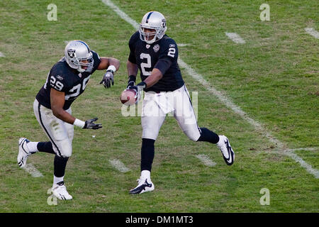 Des Raiders d'Oakland JaMarcus Russell (2) part de la boule pour des Raiders d'Oakland Michael Bush (29) au cours de l'action de jeu à la Oakland Coliseum, également connu sous le nom de ''trou noir'' à Oakland, Claif. Le dimanche, 3 janvier 2010. L'Oakland Raiders perdu pour le Baltimore Ravens 21-13. (Crédit Image : © Konsta Goumenidis ZUMApress.com)/global/Southcreek Banque D'Images